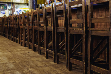 wooden chairs at the bar in the pub