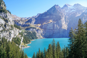 Scenic Panorama picture or postcard view of Oeschinensee lake,Wooden chalet and Swiss Alps, Beautiful outdoor scene in Berner Oberland,Kandersteg Switzerland.Vacation Holiday. 