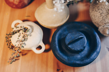 Top view collection of self-made ceramic vases and other flowerpot artwork. Authentic and one of a kind handiwork exhibition on the workshop table.