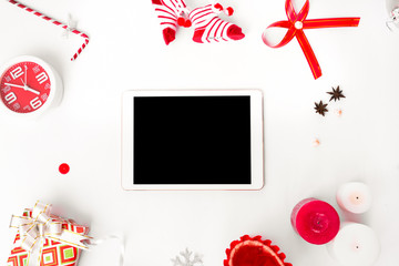 Fototapeta na wymiar stylish tablet mockup for christmas time, christmas decorations on isolated white screen, flat lay top view.