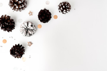 Christmas composition. Christmas gift, pine cones, fir branches on white background. Flat lay, top view