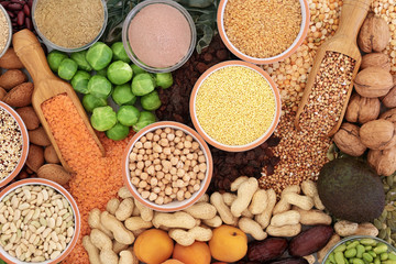 Food with high protein content with vegetables, legumes, dried fruit, nuts, seeds, grains and supplement powders. Foods high in dietary fibre, antioxidants and vitamins. Top view.