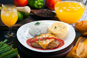 The steak parmigiana with potato and rice