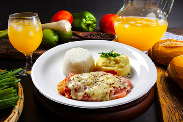 The steak parmigiana with potato and rice