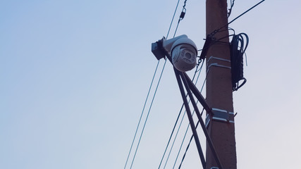 Fototapeta premium Security camera on the pole. Street video surveillance. eye of God. Tracking. Total control over people. Police surveillance.
