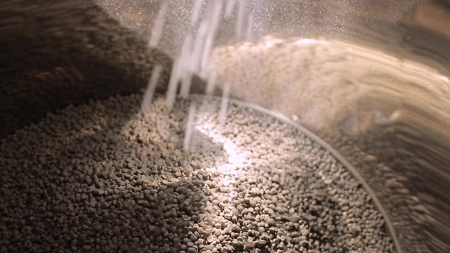 Polypropylene Plastic Material For Automotive And Plastic Industry. Falling polypropylene granules. Loading The Plastic Granules Into A Container Of The Extrusion Equipment.