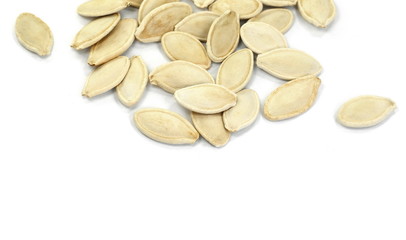 Heap of pumpkin seeds isolated on white background