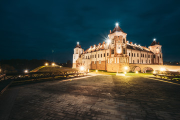 Obraz na płótnie Canvas Mir, Belarus. Castle Complex Mir In Evening Or Night Illumination. Cultural Monument, UNESCO World Heritage Site. Famous Landmark And Popular Destination In Night Llight Lighting