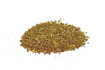 Ground or crushed brown flax seed or linseed isolated on white.