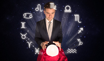Young handsome astronaut looking for inspiration in his crystal magic ball
