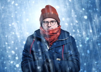 Handsome young boy shivering and trembling at snowstorm concept
