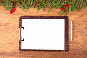 notes to do list Christmas composition. Christmas gift, pine cones, fir branches on wooden white background. Flat lay, top view