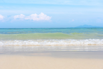 Soft wave of ocean on sand beach with blue ocean sea and sky background in summer vacation.Relaxing time on paradise.Travel,Holliday,Day off Concept. Copy space empty blank for text.