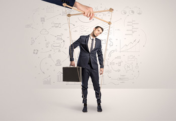 Little businessman controlled from above like a puppet concept

