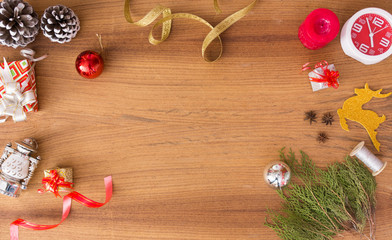 Christmas composition. Christmas gift, pine cones, fir branches on wooden golden background. Flat lay, top view
