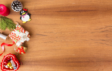 Christmas composition. Christmas gift, pine cones, fir branches on wooden golden background. Flat lay, top view