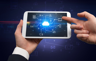 First person view of a hand using tablet with cloud office concept
