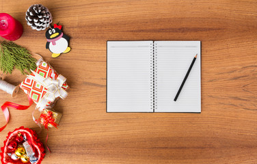 notes to do list Christmas composition. Christmas gift, pine cones, fir branches on wooden white background. Flat lay, top view