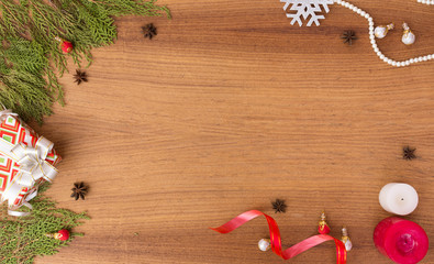 Christmas composition. Christmas gift, pine cones, fir branches on wooden golden background. Flat lay, top view