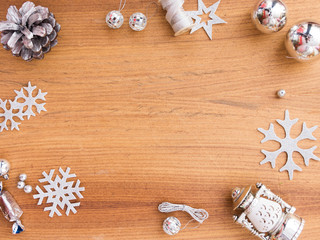 Christmas composition. Christmas gift, pine cones, fir branches on wooden golden background. Flat lay, top view