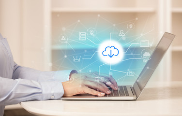 Business woman in homey environment using laptop with  online storage and cloud technology concept
