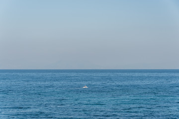 Tiny Fishing Boat on the Blue Italian Mediterranean Sea on a Clear Sunny Day