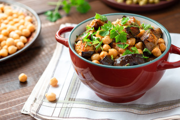 Cooked chickpeas with eggplants and parsley. Oriental food, vegetarian food.