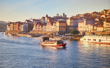 Portugal, Porto old town ribeira aerial promenade view with colorful houses, Douro river and boats.Concept of world travel, sightseeing and tourism