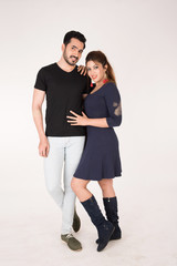 young couple together posing on white background