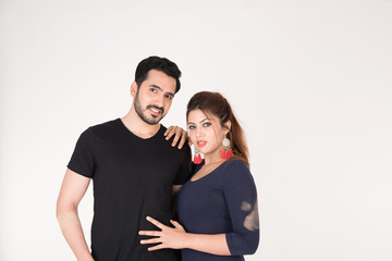 young couple together posing on white background