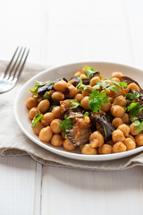 Cooked chickpeas in a plate on a light background. Vegan food.