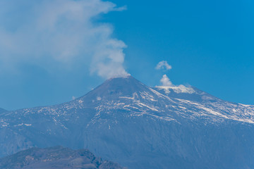 Fototapeta na wymiar Mt. Etna Volcano Emitting Smoke on a Sunny Day