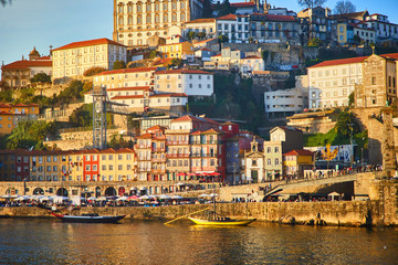 Naklejka premium Portugal, Porto old town ribeira aerial promenade view with colorful houses, Douro river and boats.Concept of world travel, sightseeing and tourism