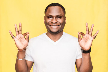 Handsome African American man shows ok sign. Body language concept.