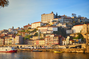 Obraz premium Portugal, Porto old town ribeira aerial promenade view with colorful houses, Douro river and boats.Concept of world travel, sightseeing and tourism