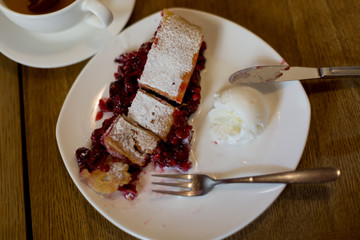 strudel with cherries. Cutlery fork and knife. dessert with tea