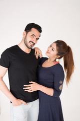 young couple together posing on white background