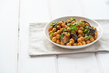 Cooked chickpeas in a plate on a light background. Vegan food.