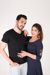 young couple together posing on white background
