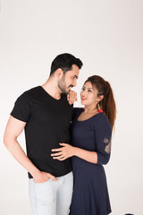 young couple together posing on white background