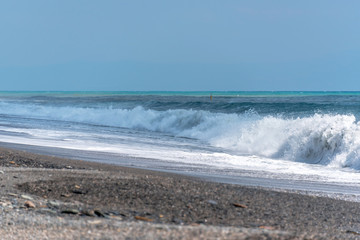 Volcanic Black Sand Beach and Blue Ionian Sea in Sicily