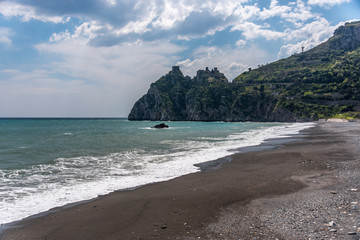 Volcanic Black Sand Beach and Blue Ionian Sea in Sicily