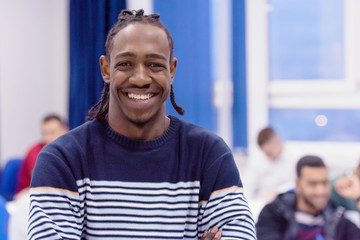 African american university male student in class  smiling at the camera.