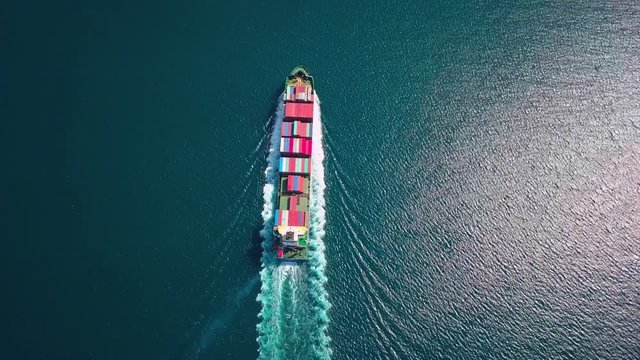 Aerial footage of ultra large container ship at sea, top down view
