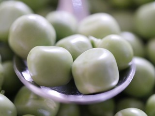 green peas on black background