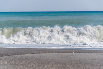 Cloudscape and Volcanic Black Sand Beach and Blue Ionian Sea in Sicily