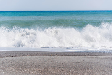 Cloudscape and Volcanic Black Sand Beach and Blue Ionian Sea in Sicily