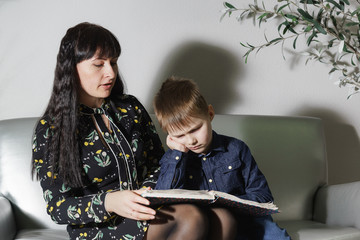 Mother and son learn lessons. The boy is tired, does not want to read and angry