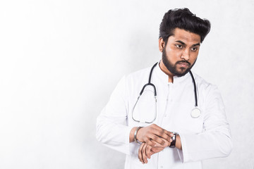 Fototapeta premium Handsome young doctor in a white coat with a stethoscope. Health care concept.