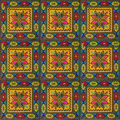 Seamless pattern of squares with ornaments, embroidered with colored threads